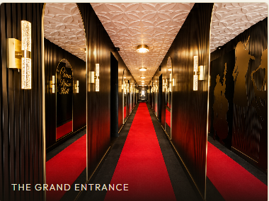 The gold-lit mirrored grand entrance with red carpet