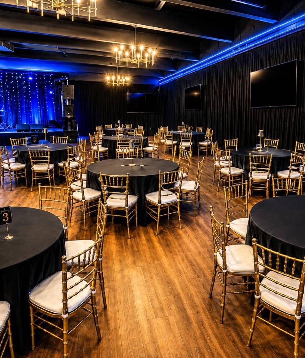 The hall set with round banquet tables for a celebration
